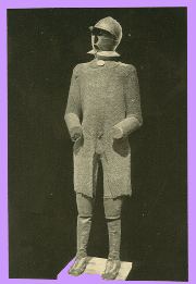 A black and white photograph of a museum display of a figure clad in chain armour of the type used in the Iberian Peninsula towards the end of the 14th century.